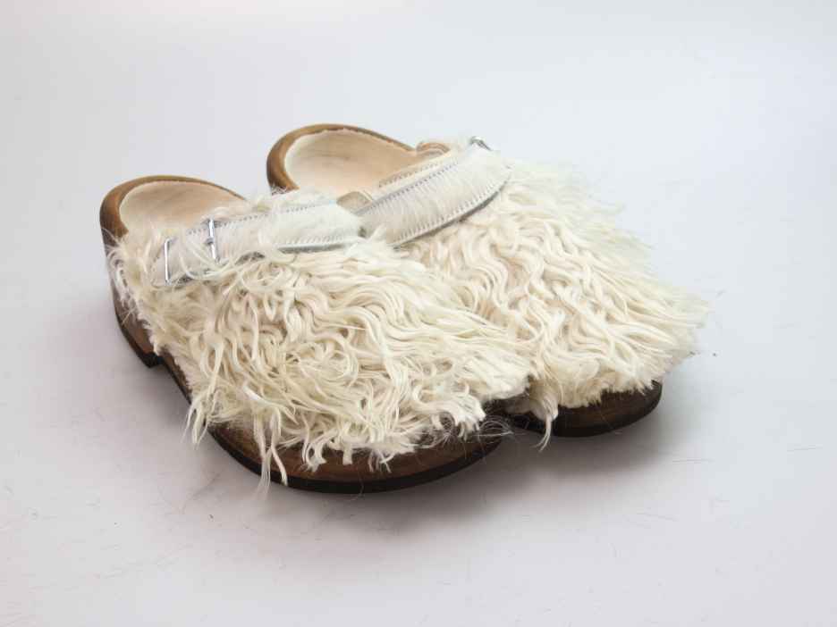 Holzschuh in langem Ziegenfell mit Schaffell